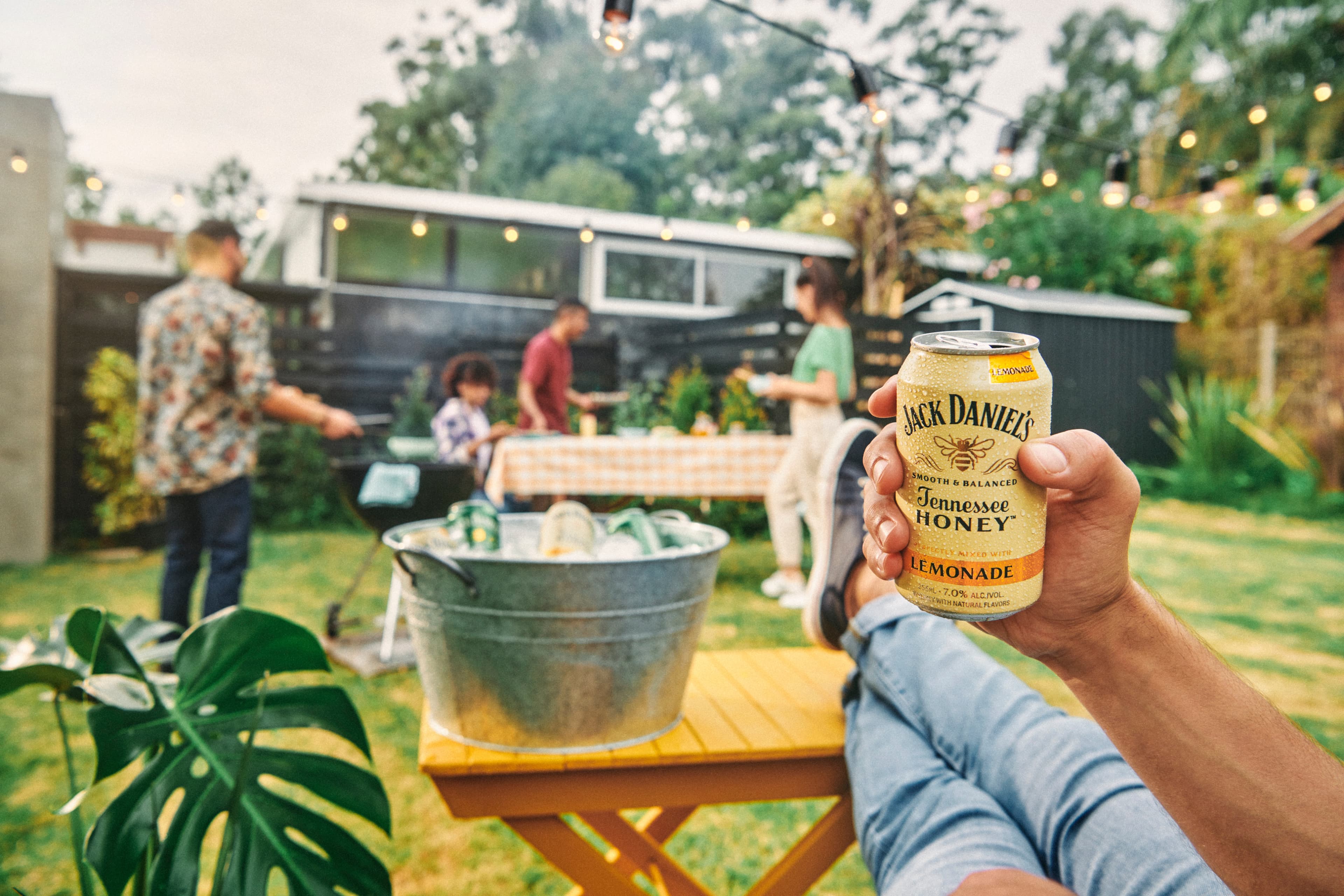 Backyard bbq with cans of tennessee honey lemonade.