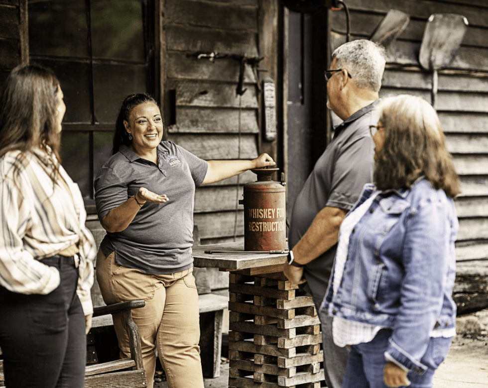Group of 3 people during the jack daniel distillery tour talking to a master distiller