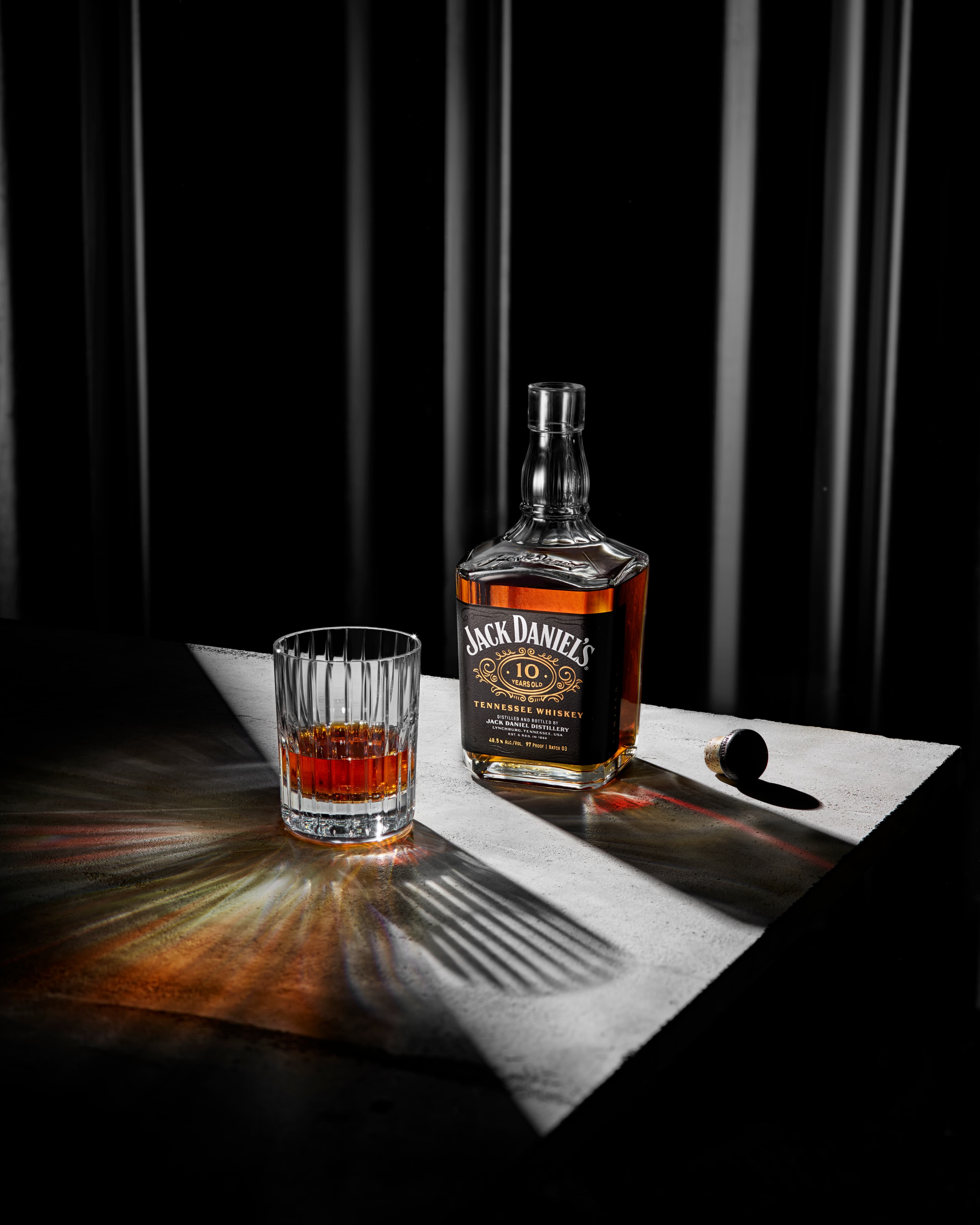 10 year bottle next to a glass of whiskey