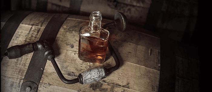 Taste testing whiskey from the barrel